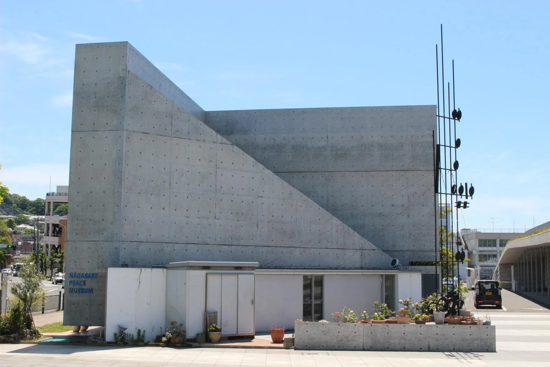 Sunlit concrete façade of the Nagasaki Peace Museum in Matsugae-cho, a quiet modernist landmark dedicated to global peace and art.
