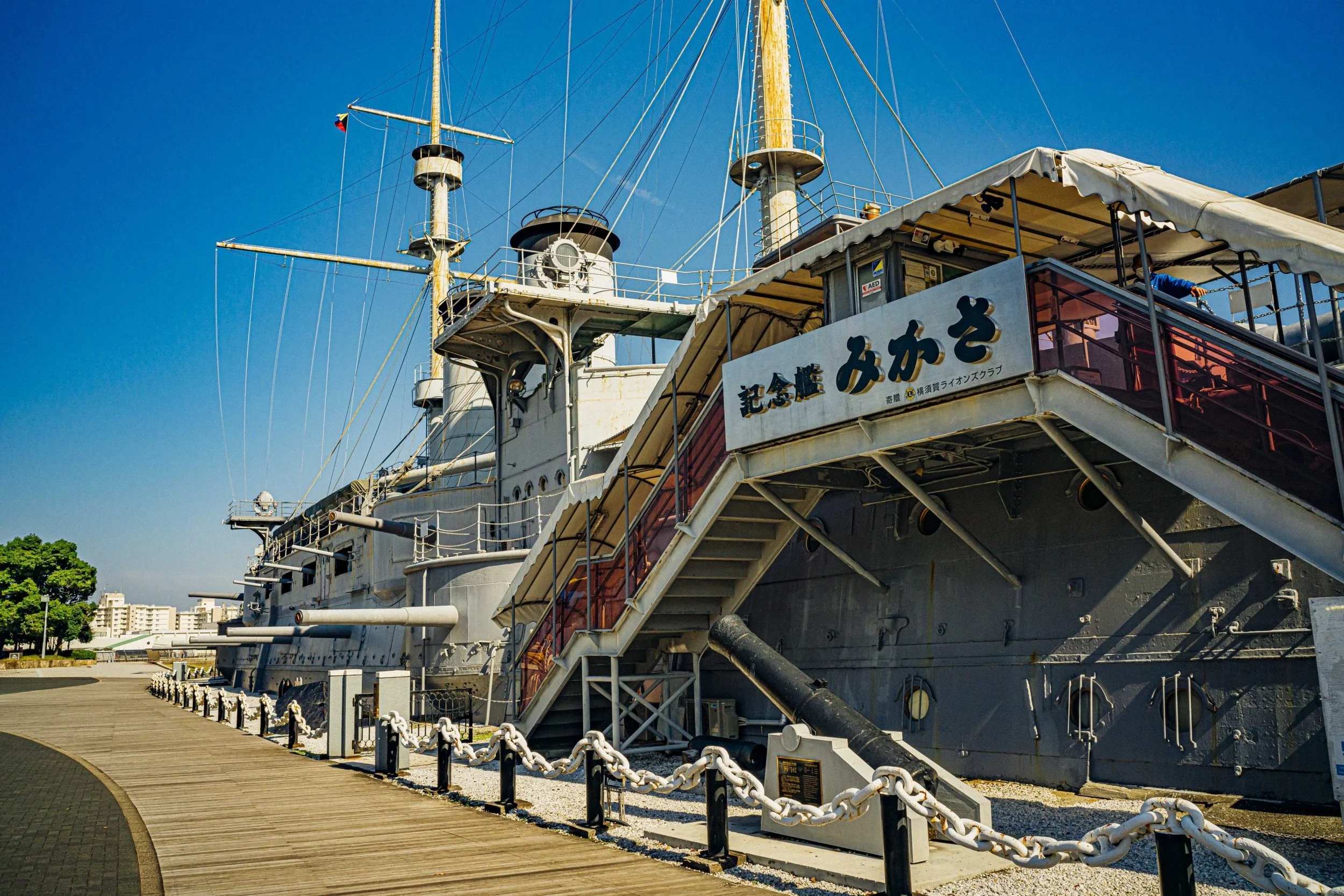 Memorial Ship Mikasa preserved on Yokosuka's waterfront under clear blue sky — Admiral Togo's historic flagship from the Battle of Tsushima.