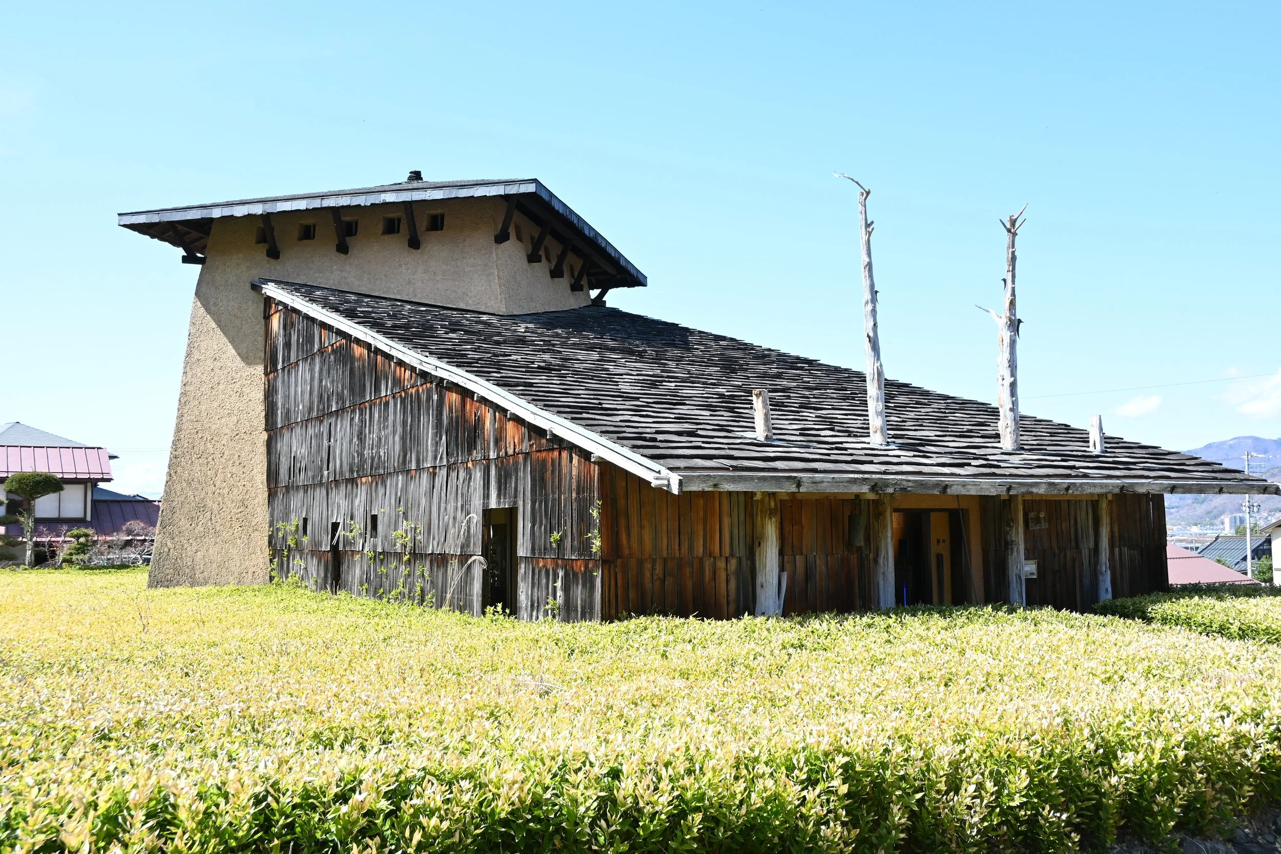 Weathered timber and earthen plaster museum by Terunobu Fujimori in Chino, Nagano — a hidden gem of Shinto heritage and architectural art.