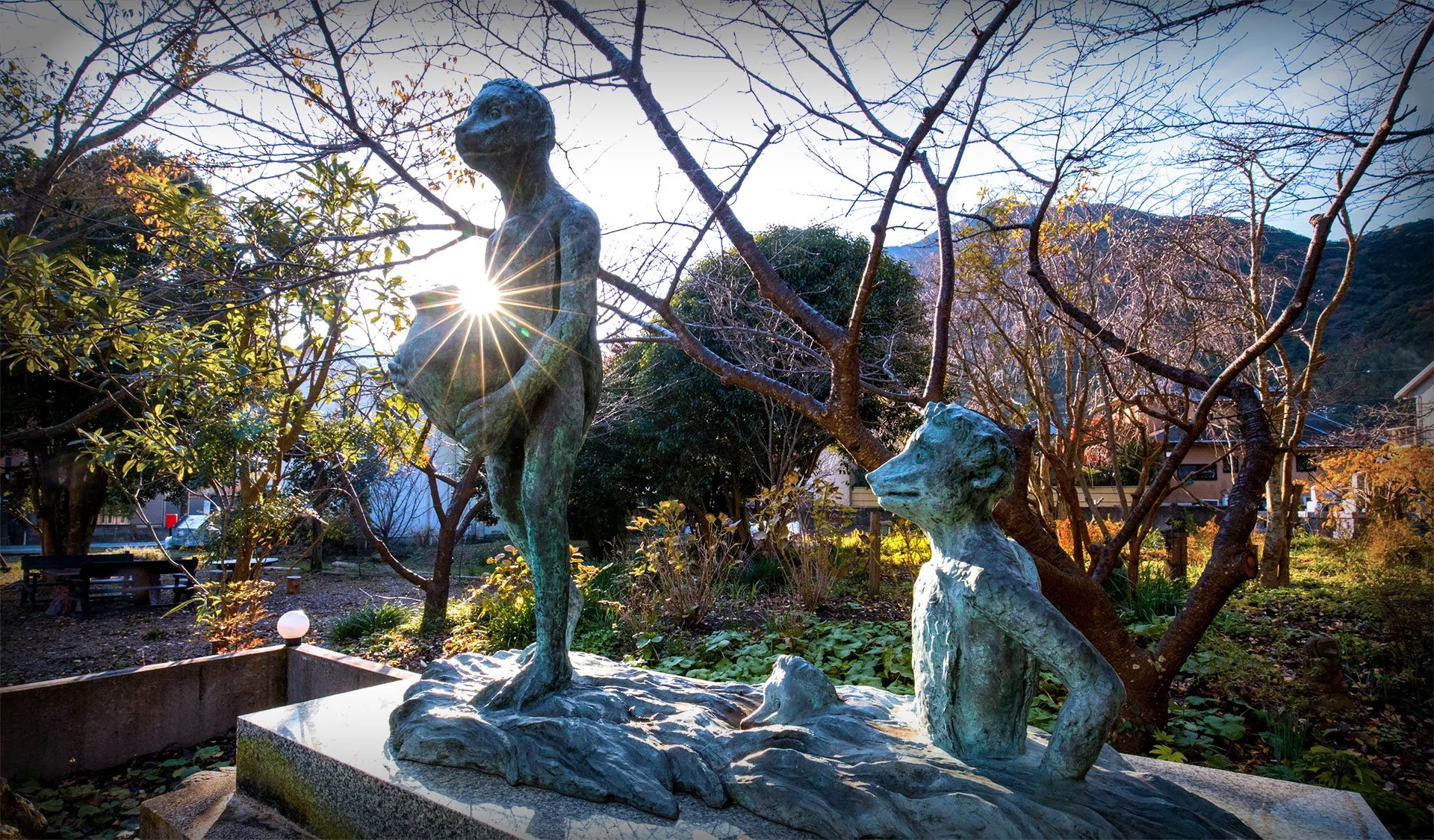 Bronze kappa statues glowing in soft sunlight at Seisokuji Temple garden, Kawazu — a 700-year-old hidden gem of Japanese folklore.