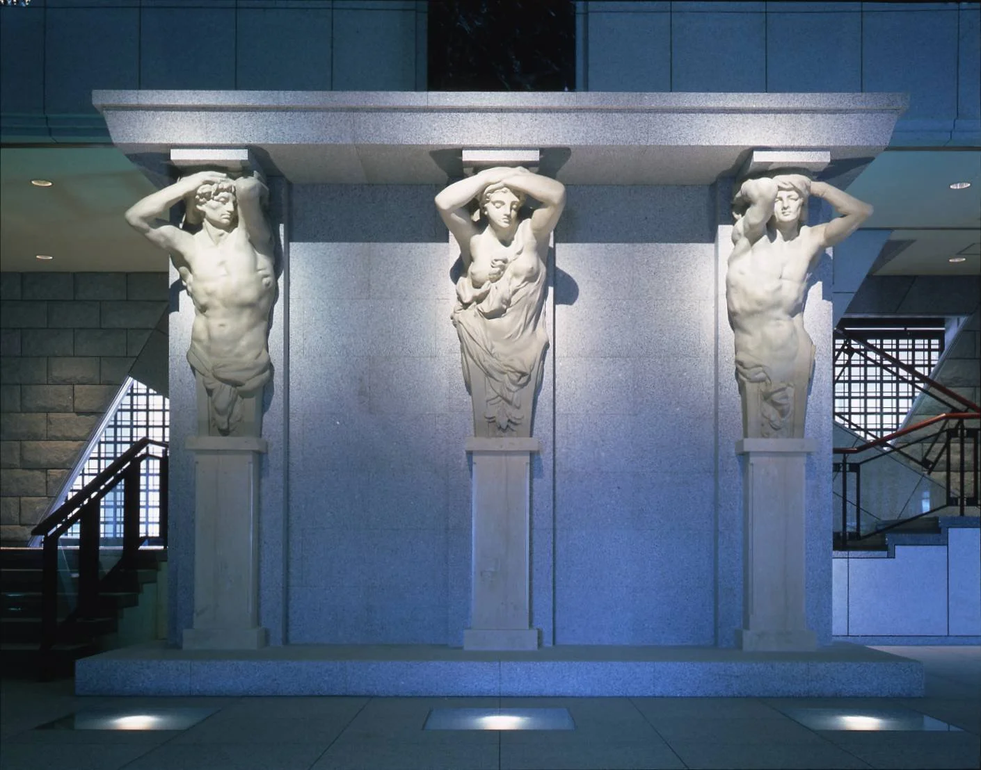 Three pale stone Caryatid and Atlantes sculptures at the entrance of Niigata Prefectural Museum of Modern Art, Nagaoka — rare early works from 19th-century Brussels.