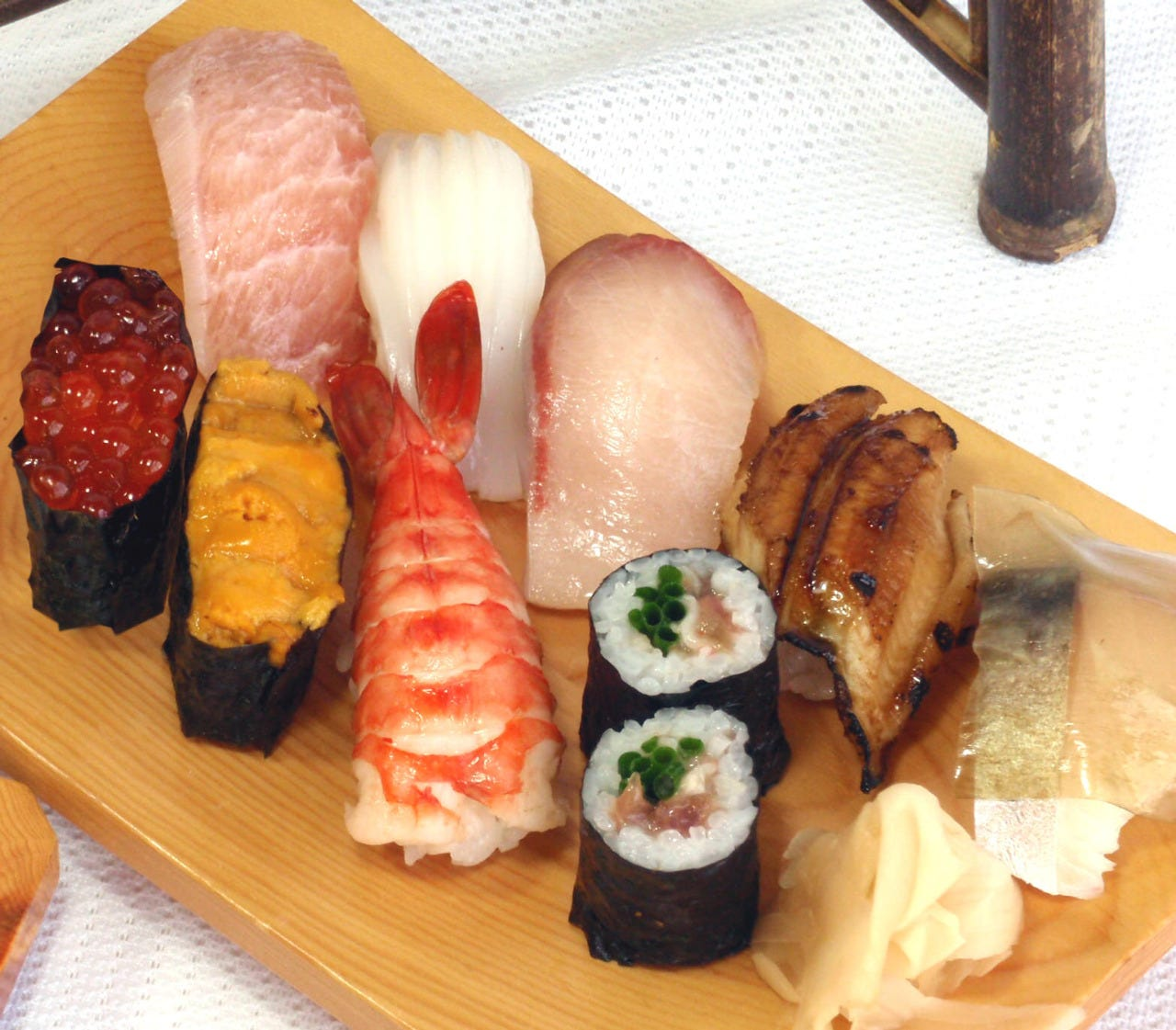 Display of packaged cookies with labels that feature a cartoon character holding a leaf, on a wooden surface.