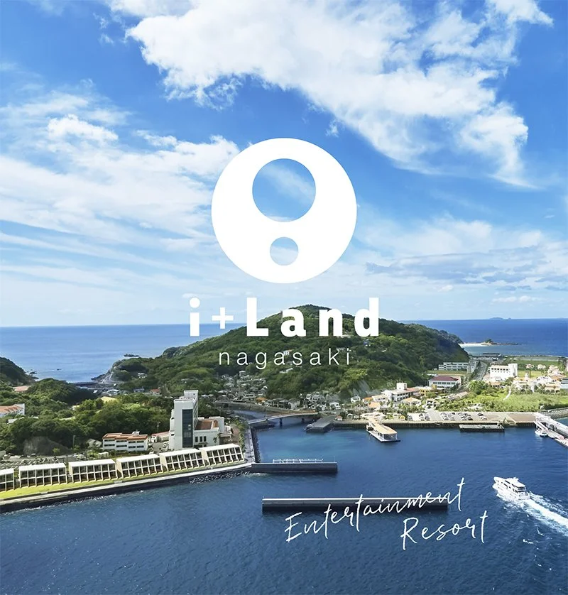 Aerial view of i+Land nagasaki resort on Iojima Island, with deep blue sea, harbor piers and green coastal hills.