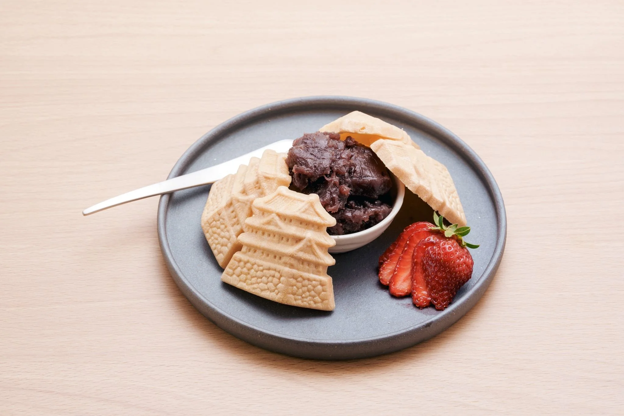 A modern building with glass doors and windows, decorated with flags and signs, including a cartoon tiger mascot wearing a white hat and cape, outdoors on a sunny day with trees in the background.