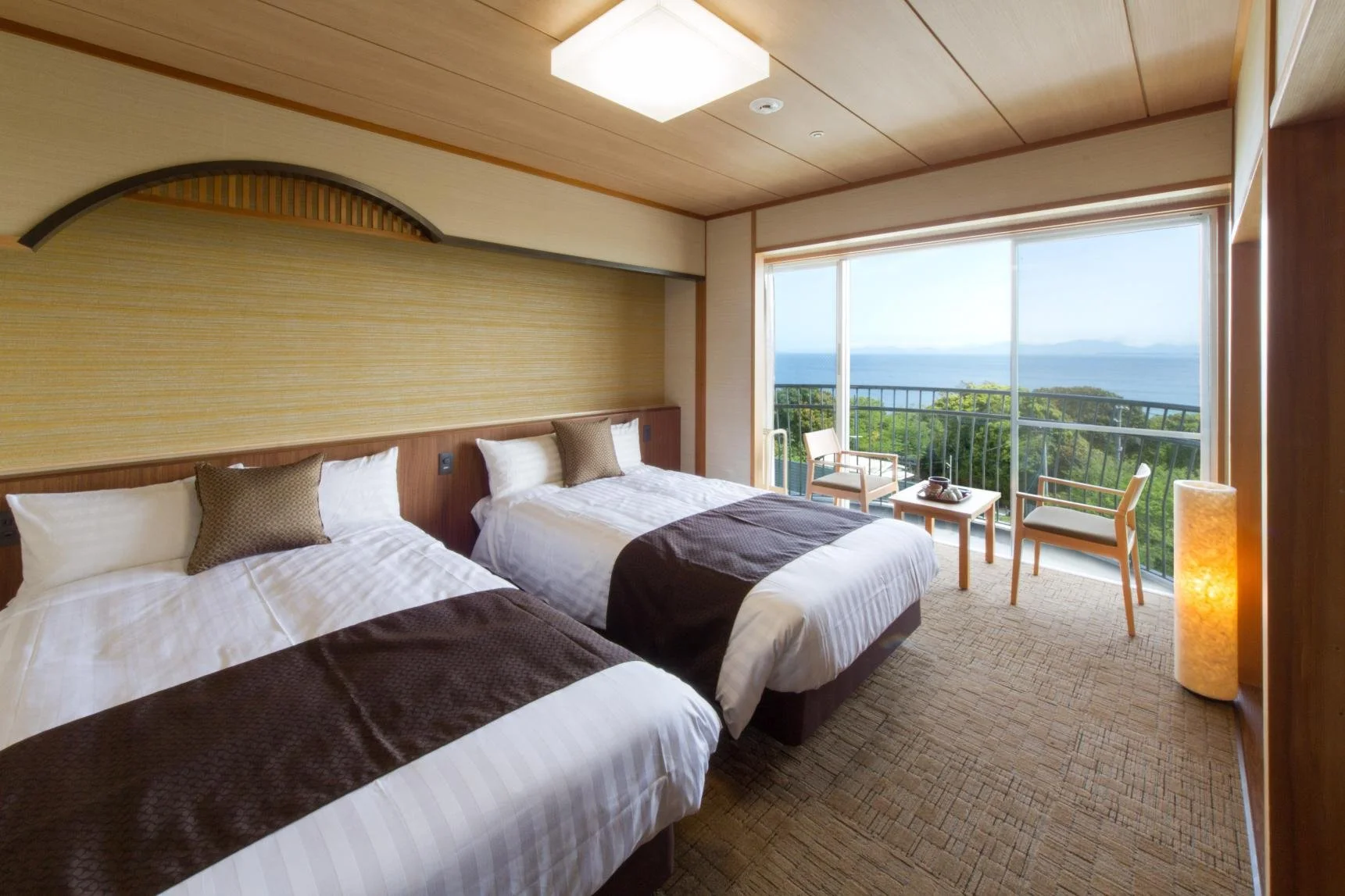 Young girl dressed in traditional Japanese attire hitting a large taiko drum during a cultural festival.