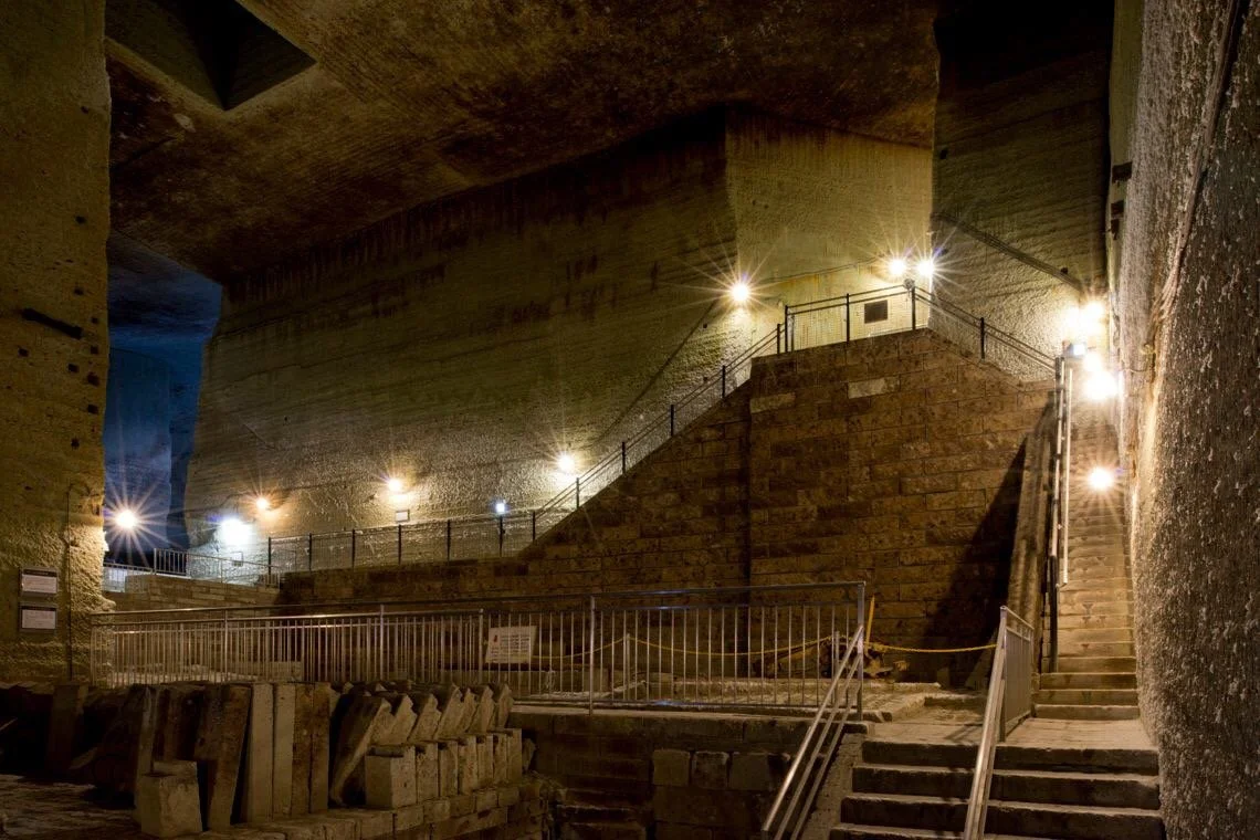 Vast underground stone chambers of the Oya History Museum in Utsunomiya, with carved walls and dramatic lighting illuminating the former Oya Stone quarry.
