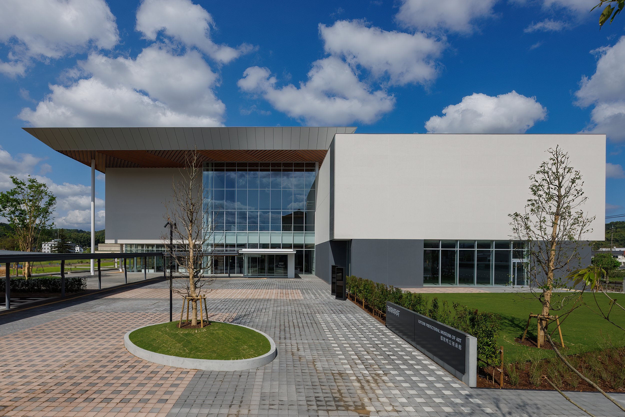 Modern glass-and-wood facade of Tottori Prefectural Museum of Art in Kurayoshi — a new cultural landmark in rural Japan.