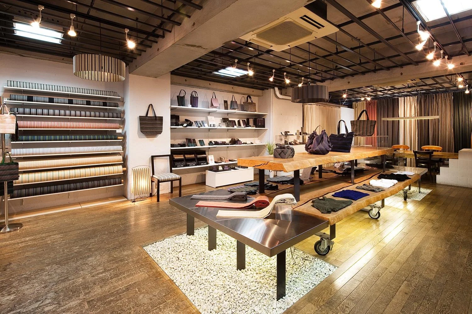 A dessert served in a tall glass with various toppings like fruit, beans, and cookies, viewed on a tray with a blurred background.