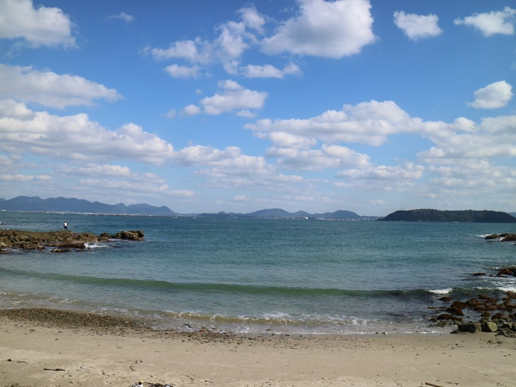 Calm teal sea and distant island views from the rocky shoreline of Ainoshima, a peaceful fishing island north of Kokura in Kitakyushu.