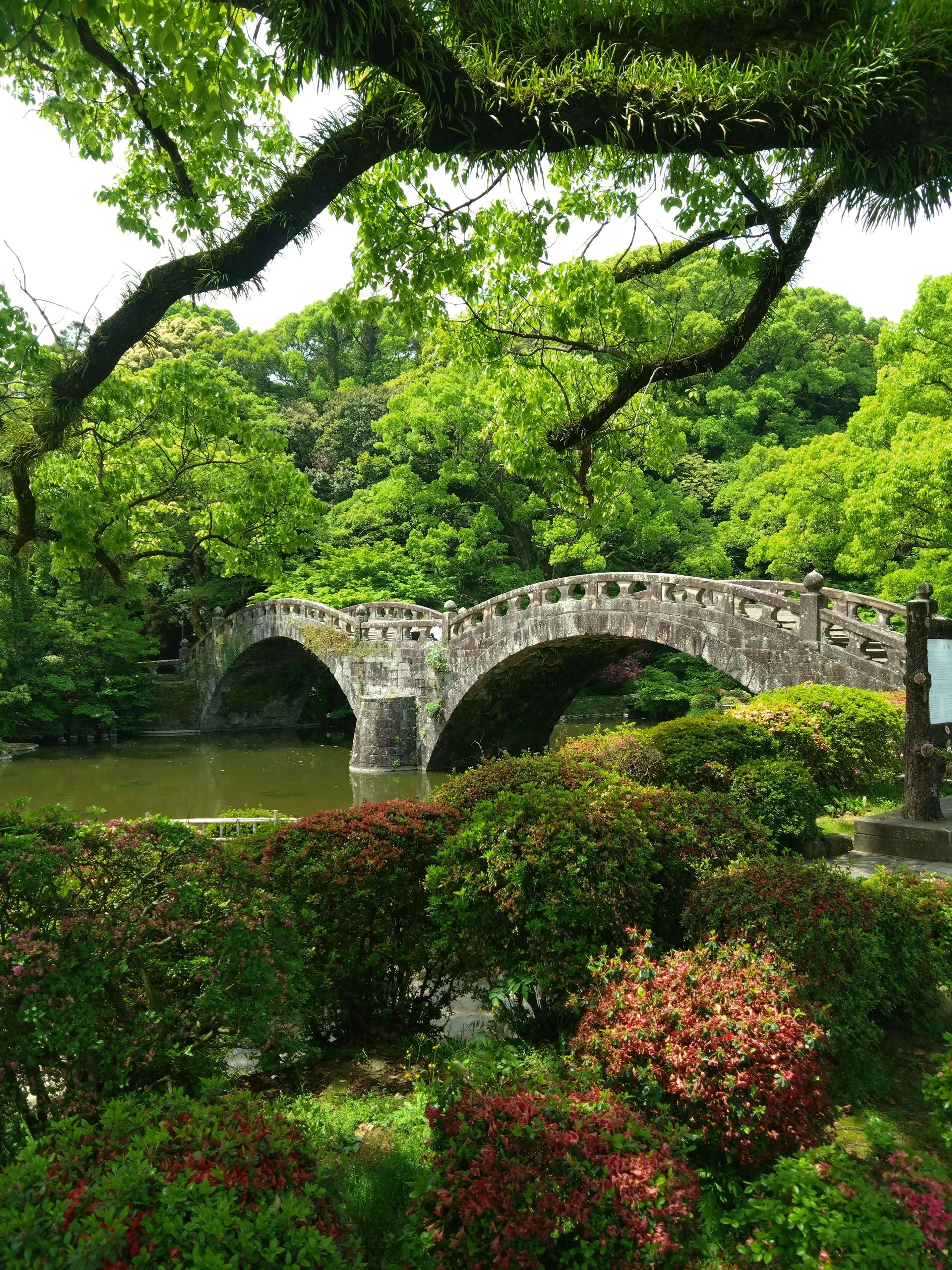 Stone arch bridge in Isahaya Park, Nagasaki — Japan's most beautiful historic bridge, a peaceful hidden gem far from the crowds.