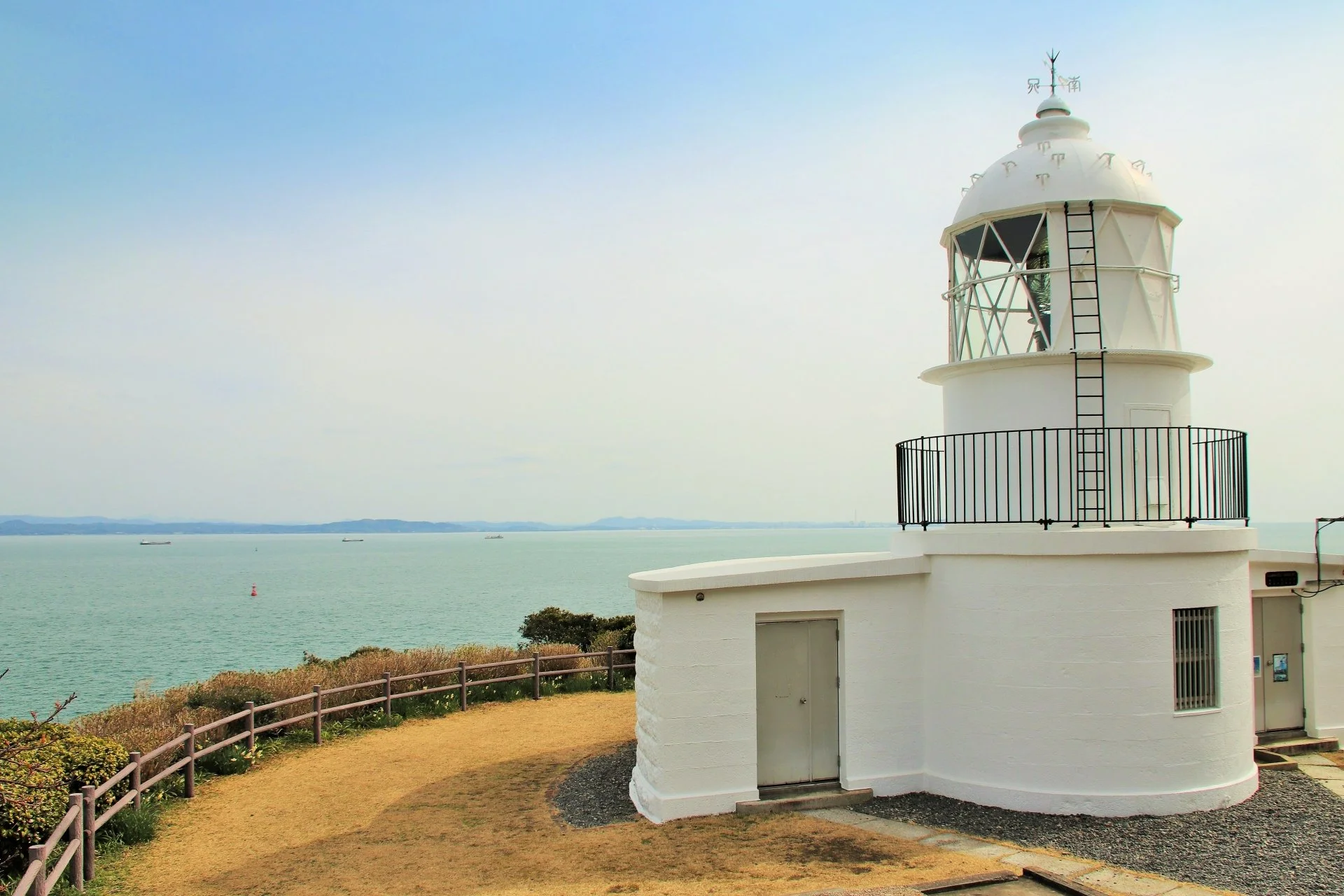 Hesaki Lighthouse, the oldest surviving lighthouse in Kyushu, standing on a coastal hill overlooking the Kanmon Strait in Kitakyushu.