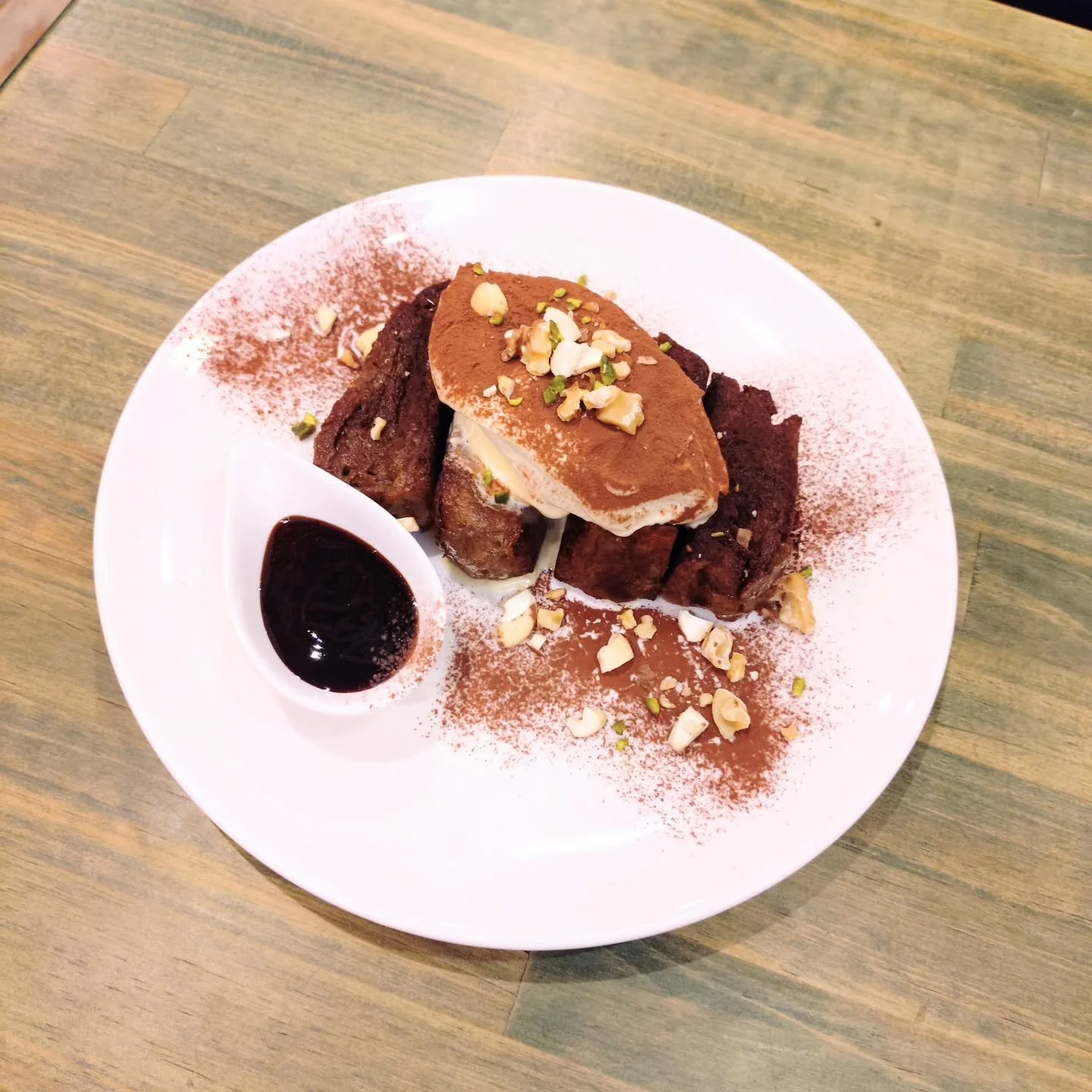 Young girl dressed in traditional Japanese attire hitting a large taiko drum during a cultural festival.