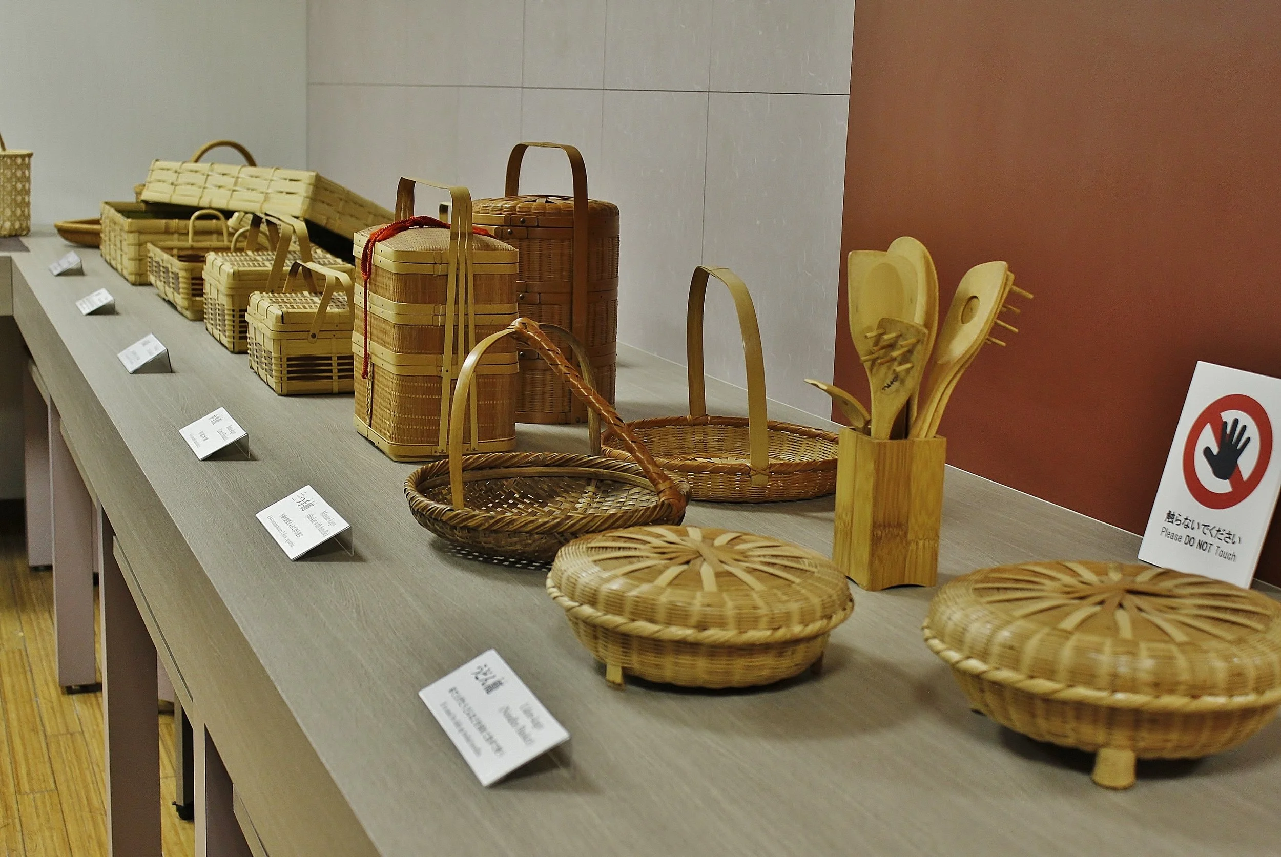 A museum display of handwoven bamboo baskets and vessels at Beppu's traditional crafts center — a living showcase of Japan's bamboo artistry.