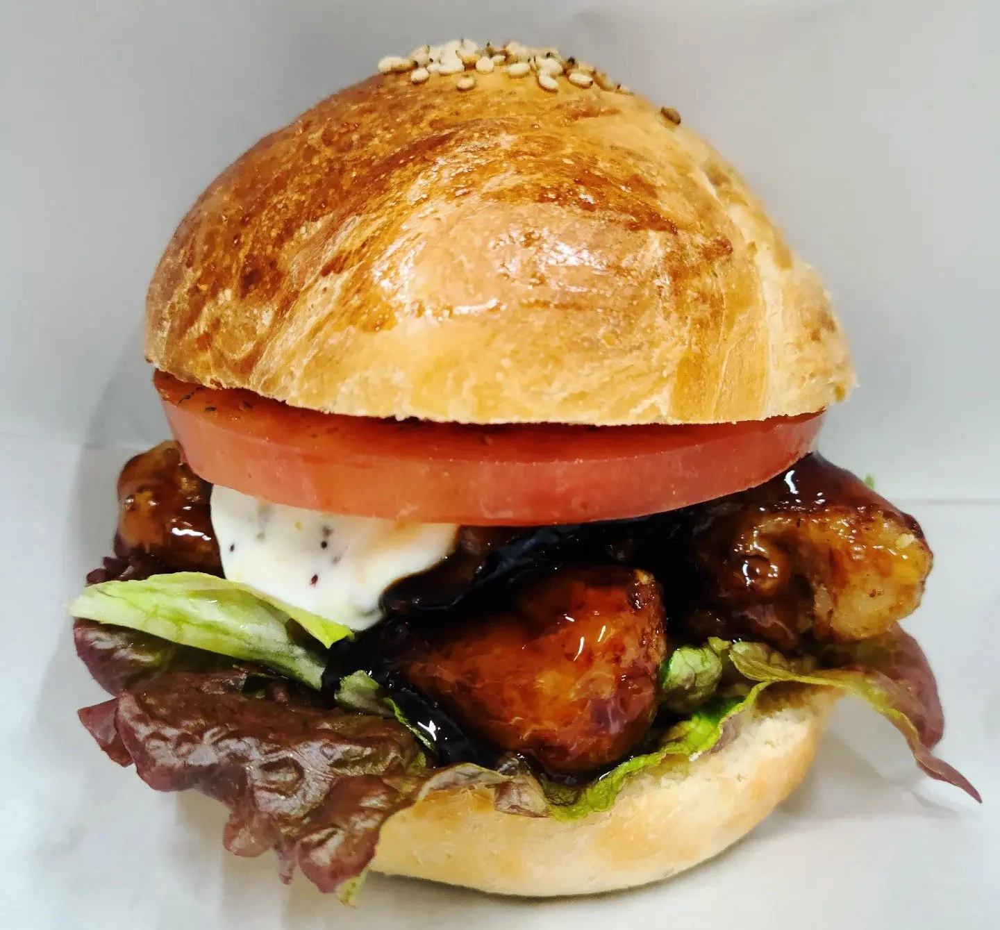 Soy Nyama Burger with teriyaki-glazed soy patty, fresh lettuce, and tomato on a sesame bun at Pachoko, Ogawa Village Nagano.