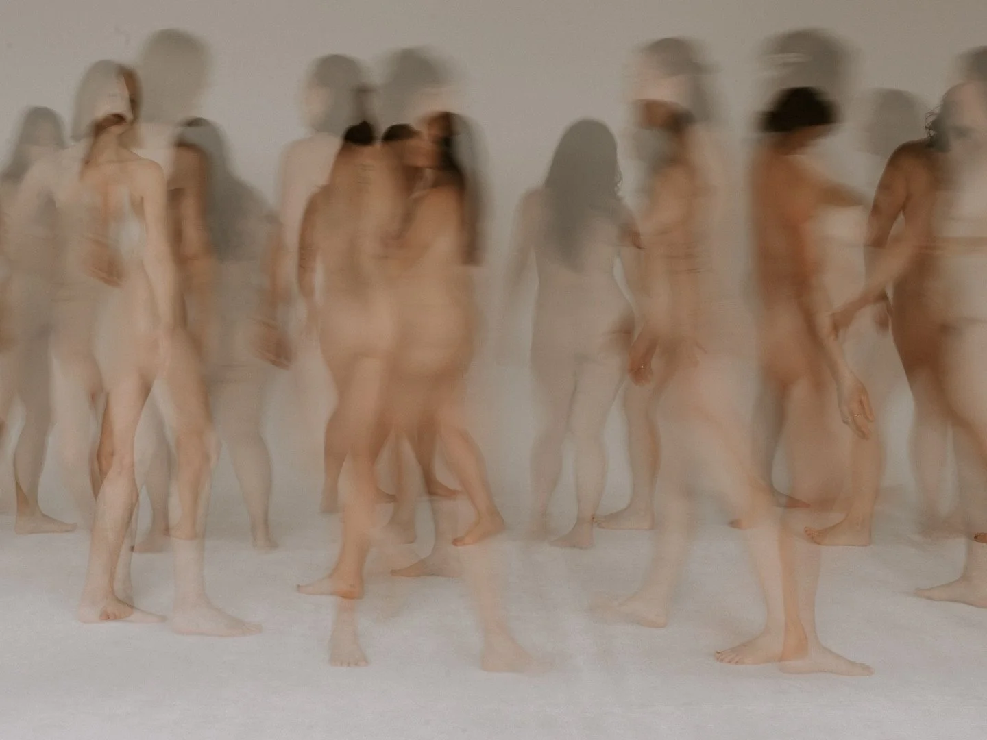 Photograph by photographer Martine Payne of a group of nude women walking. The image is blurred and the bodies are out of focus.