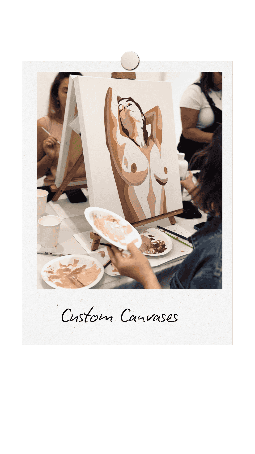 Paint and Sip Sydney. A Custom Canvas of a female nude torso is being painted in beige colours by a woman with her back to the camera. Other women are painting in the background as a part of a Hens Party.