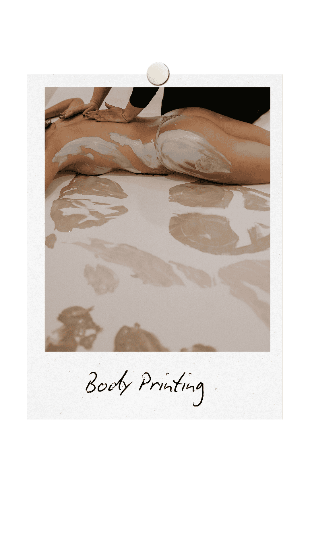 Nude woman laying down with paint on her body, having the paint and her body printed onto paper. Other painted prints are on the paper in the foreground. The paints are in shades of beige.