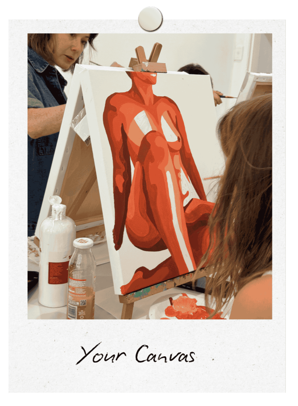 Custom Canvas paint and sip in Newcastle. There is a canvas with a nude female sitting with leg bent being painted in shades of orange. There are women in the fore and background painting their canvases too.