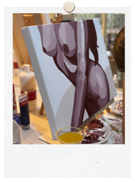 Baby shower private event. Custom Canvas of a female body in paint by numbers style painted in shades of brown. Paint tray and margarita on the table with tubes of paint around.