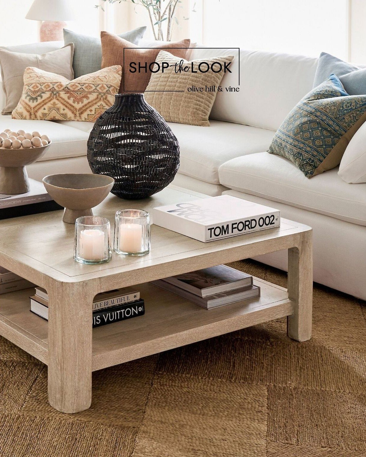Styling starts with standout pieces. This high-back chaise sectional with linen pillows anchors the space, while a weathered sandwash coffee table, hand-stitched diamond jute rug, and designer books give it that layered, lived-in feel. 

Comment SHOP