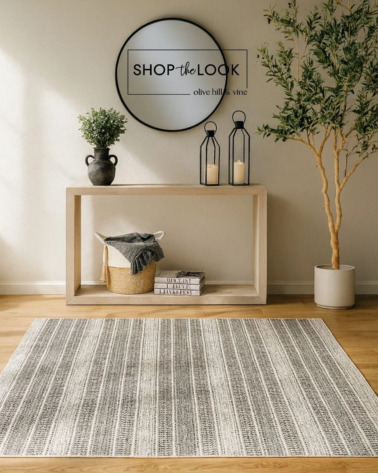 First impressions matter&mdash;this curated entryway combines a round mirror, faux olive tree, rustic vase, lanterns, and a striped rug, all for under $900. Stylish, inviting, and effortless. 

Comment SHOP below to receive a DM with the link to this