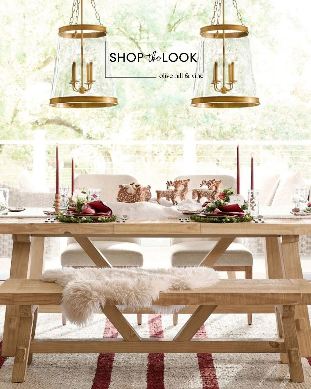 Gather around a holiday table that feels straight out of a storybook. A farmhouse trestle table and bench pair beautifully with upholstered chairs, vintage brass lighting, red jute rug, and gingerbread stoneware for a festive setting full of warmth a