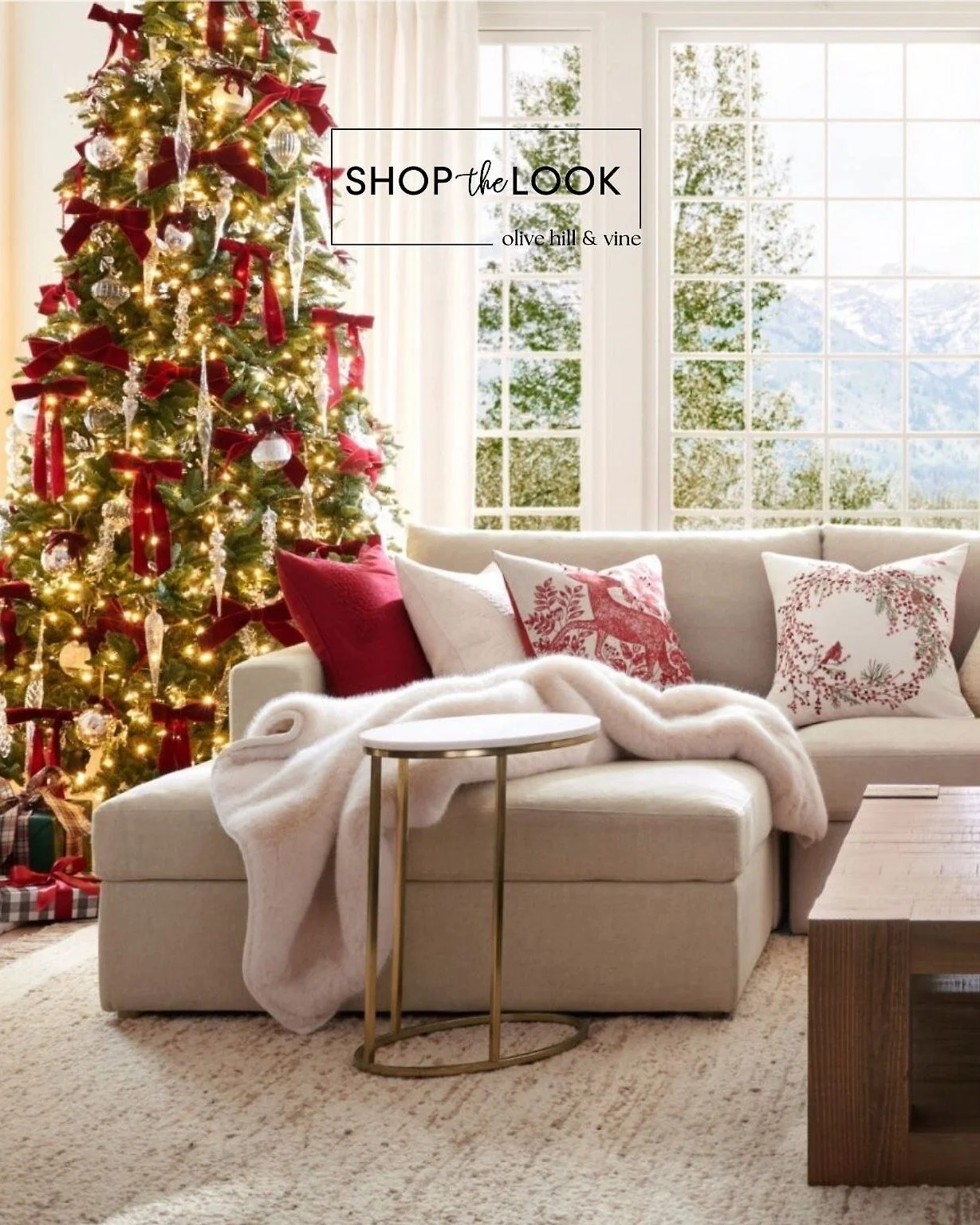 A warm holiday living room shines with a plush sectional, festive red-and-cream pillows, a glowing Christmas tree, and a rustic wood coffee table. Layered textures, sparkling accents, and classic seasonal touches bring timeless Christmas charm to any