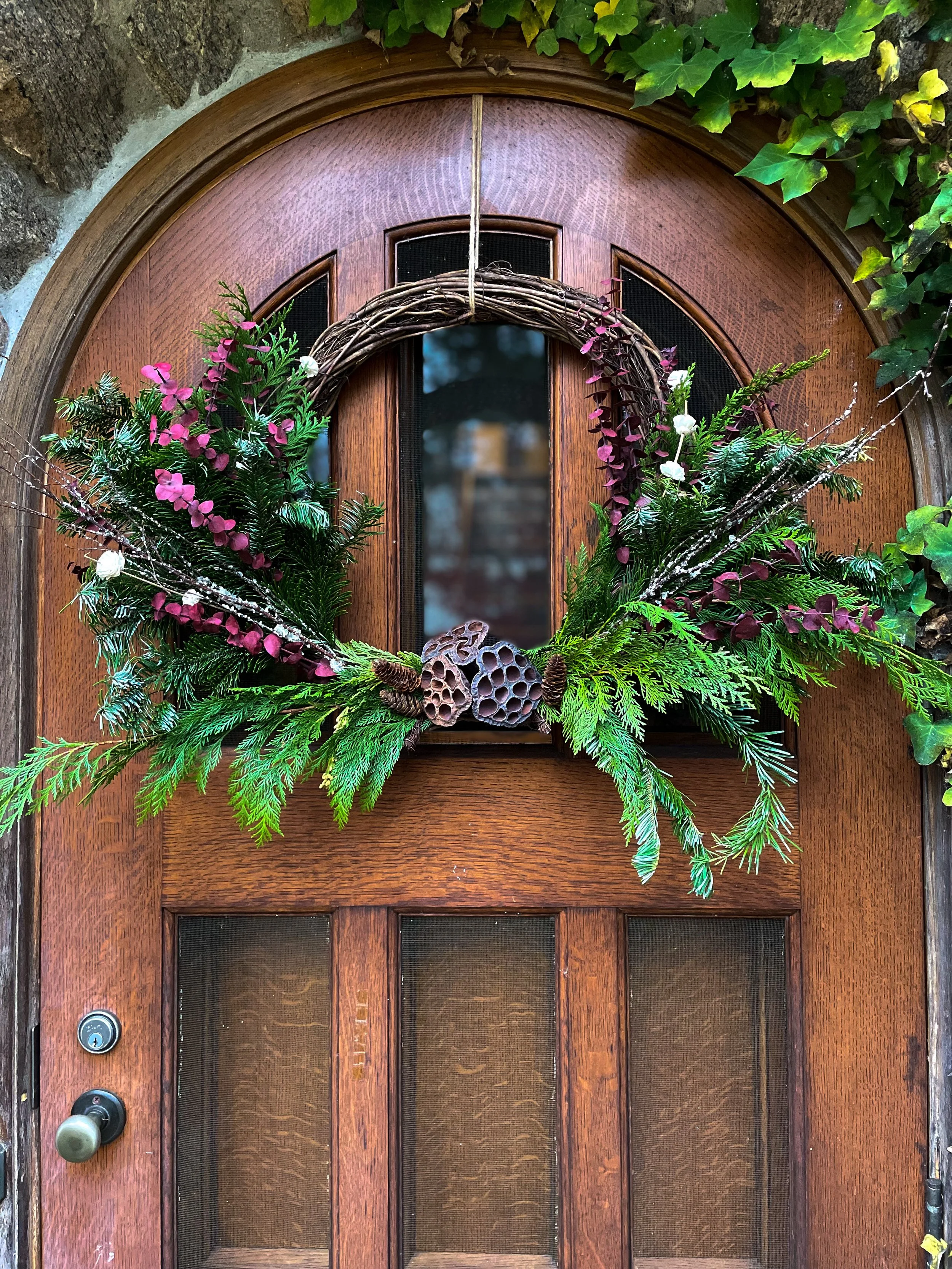 Unique holiday wreaths with live greens and dried flowers.