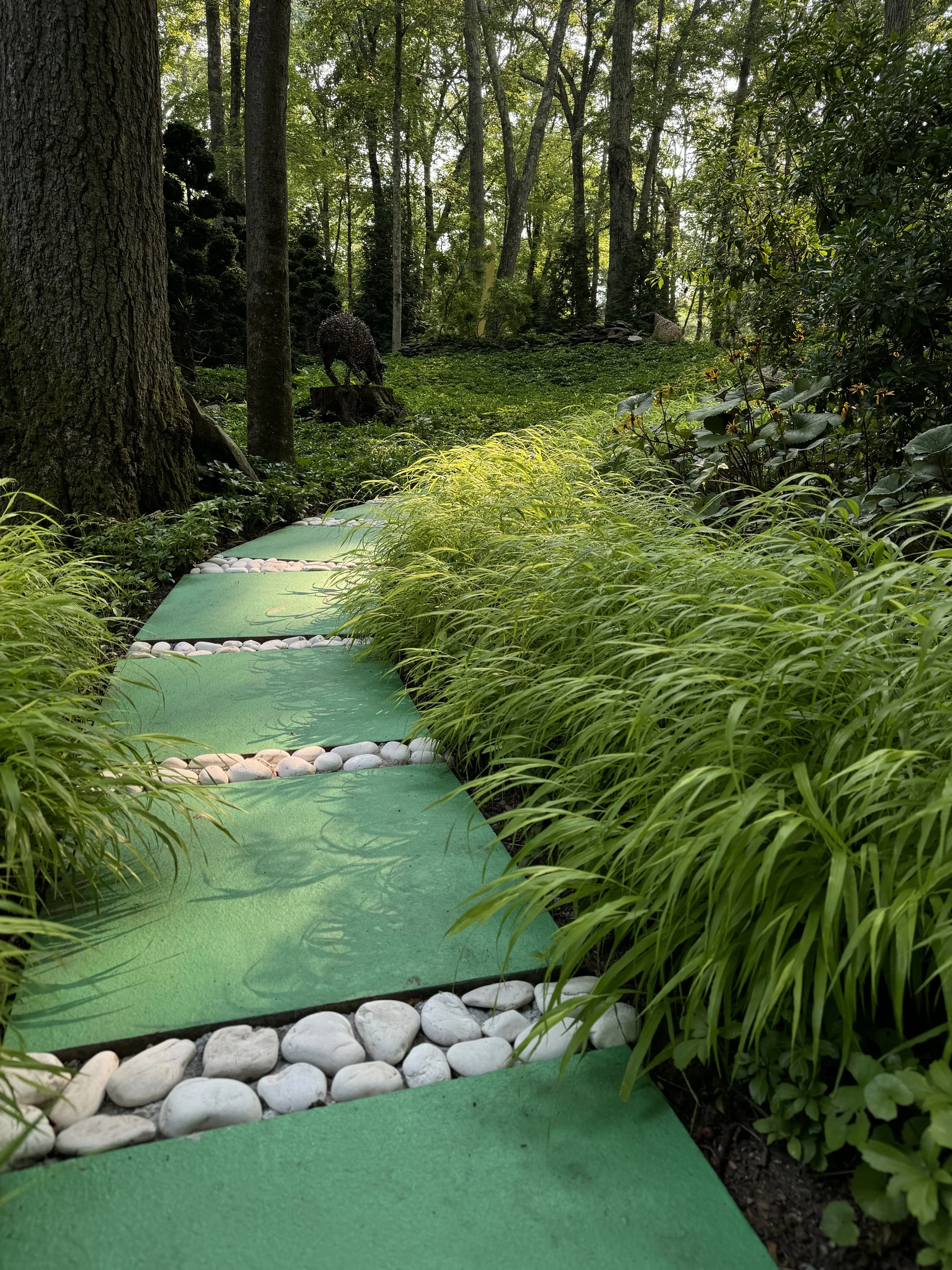 Hand-painted woodland pathway with smooth white river rocks.