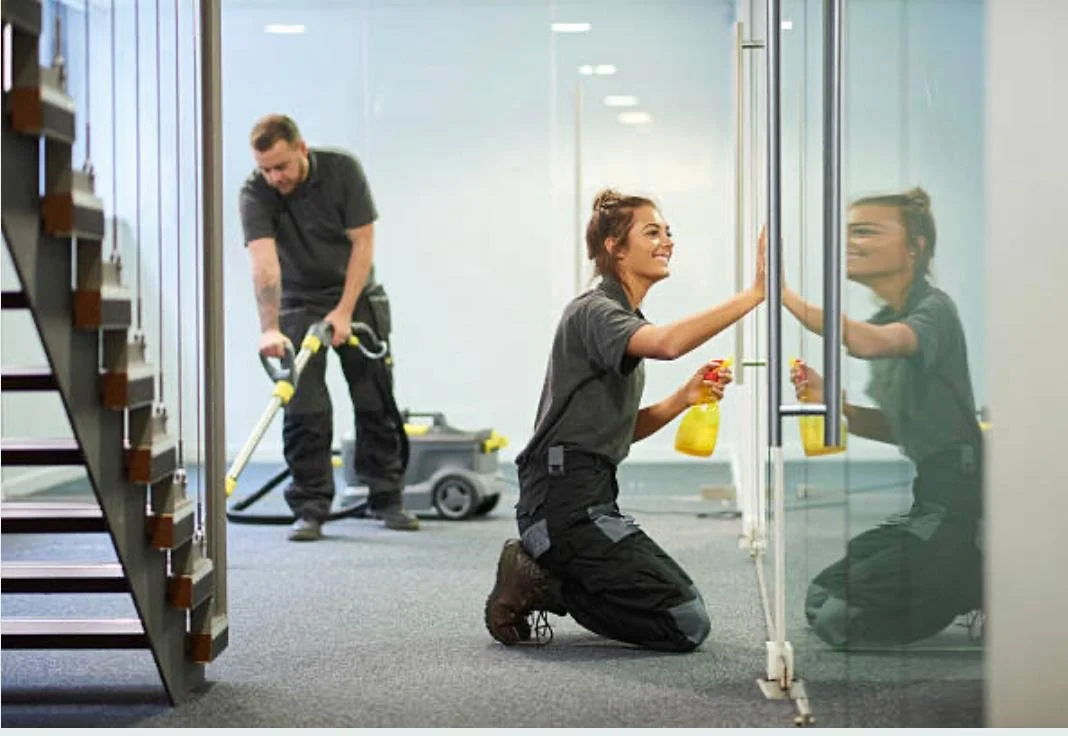 Two people cleaning a commercial building