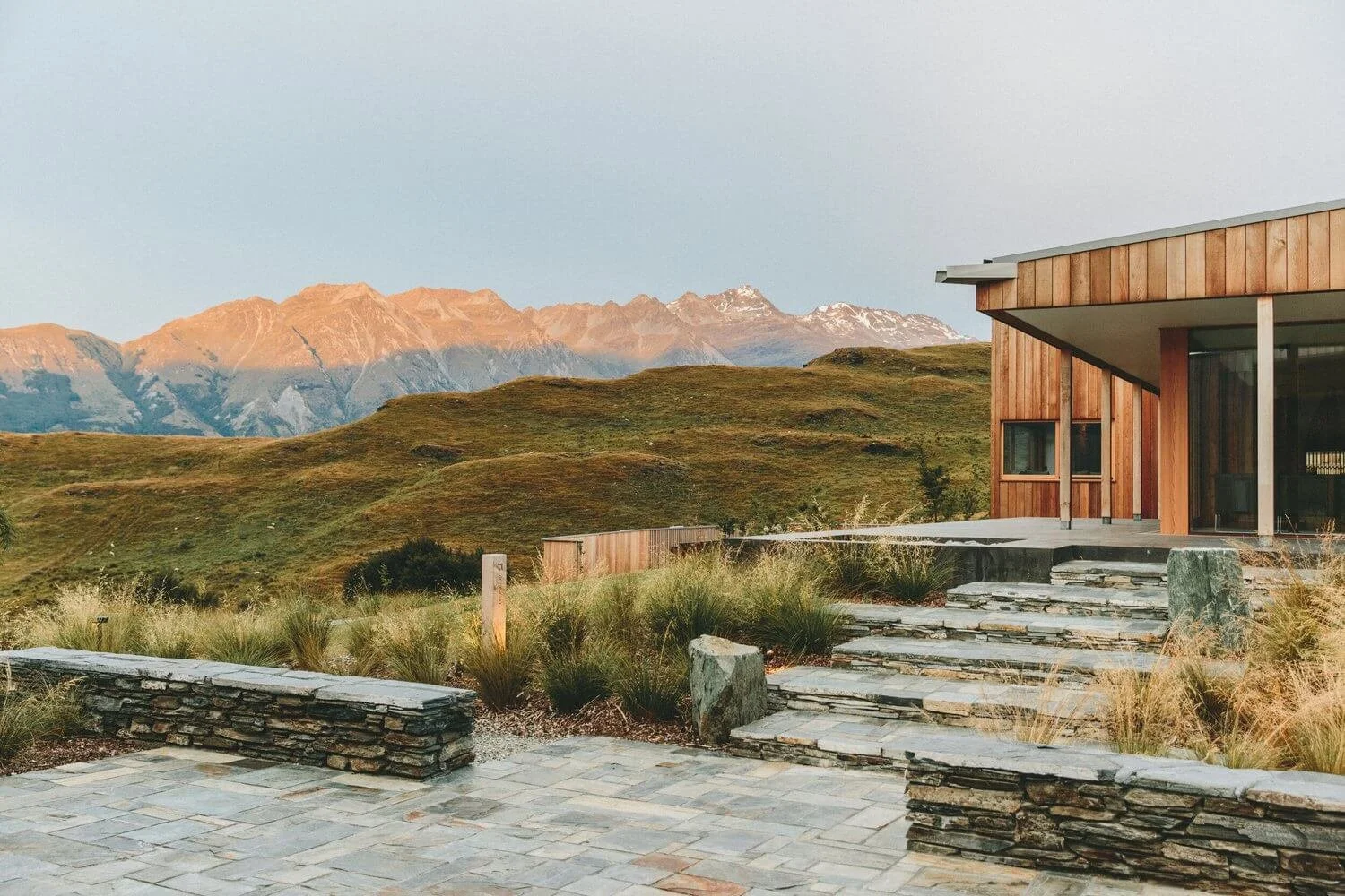 Wood structure and rock floor with mountains in the background