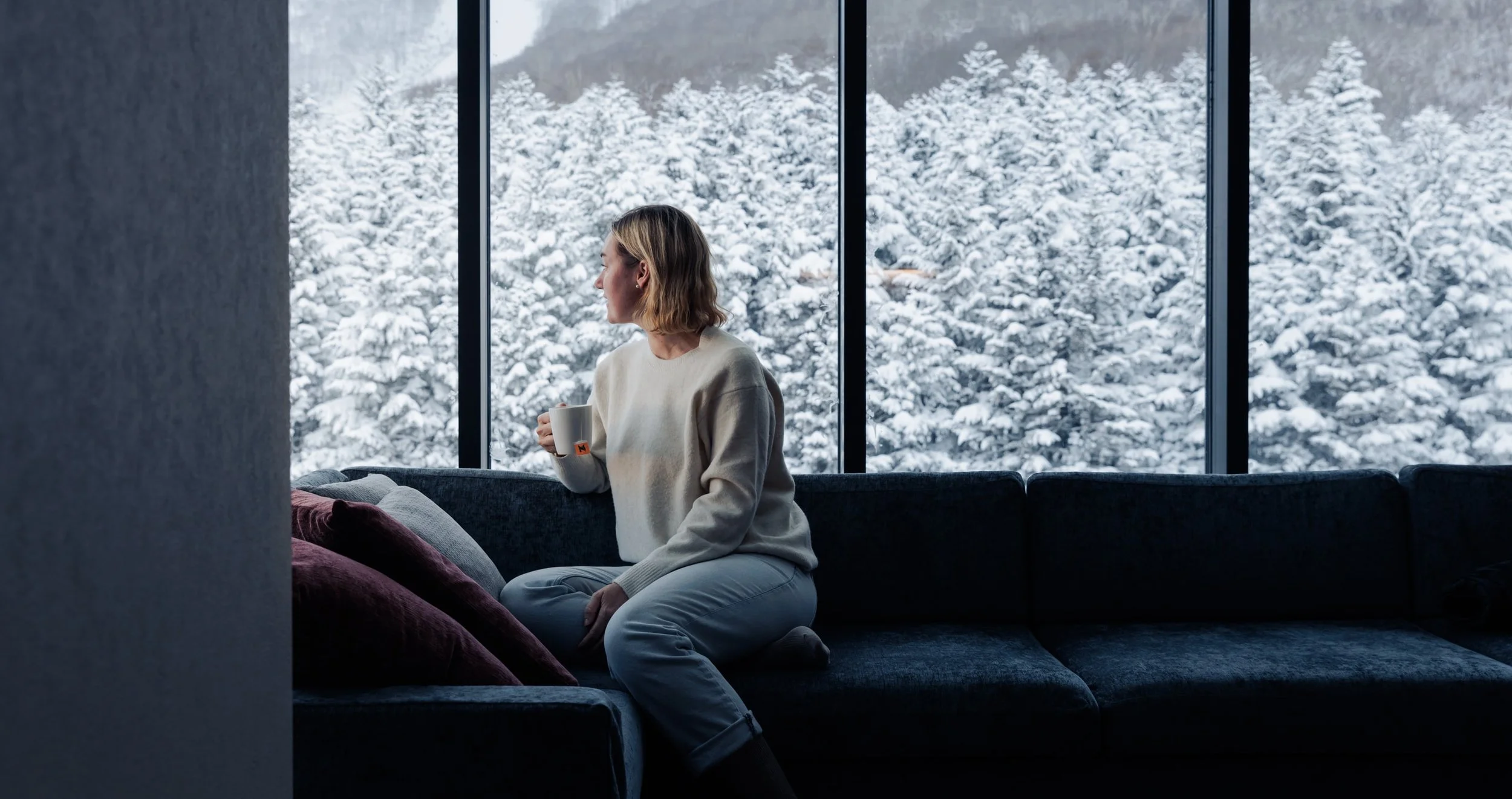 Woman Enjoying Living Room View - The Vale Rusutsu - Rusutsu