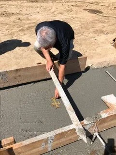 Fr.-Timothy-placing-cross-in-cement1.jpg