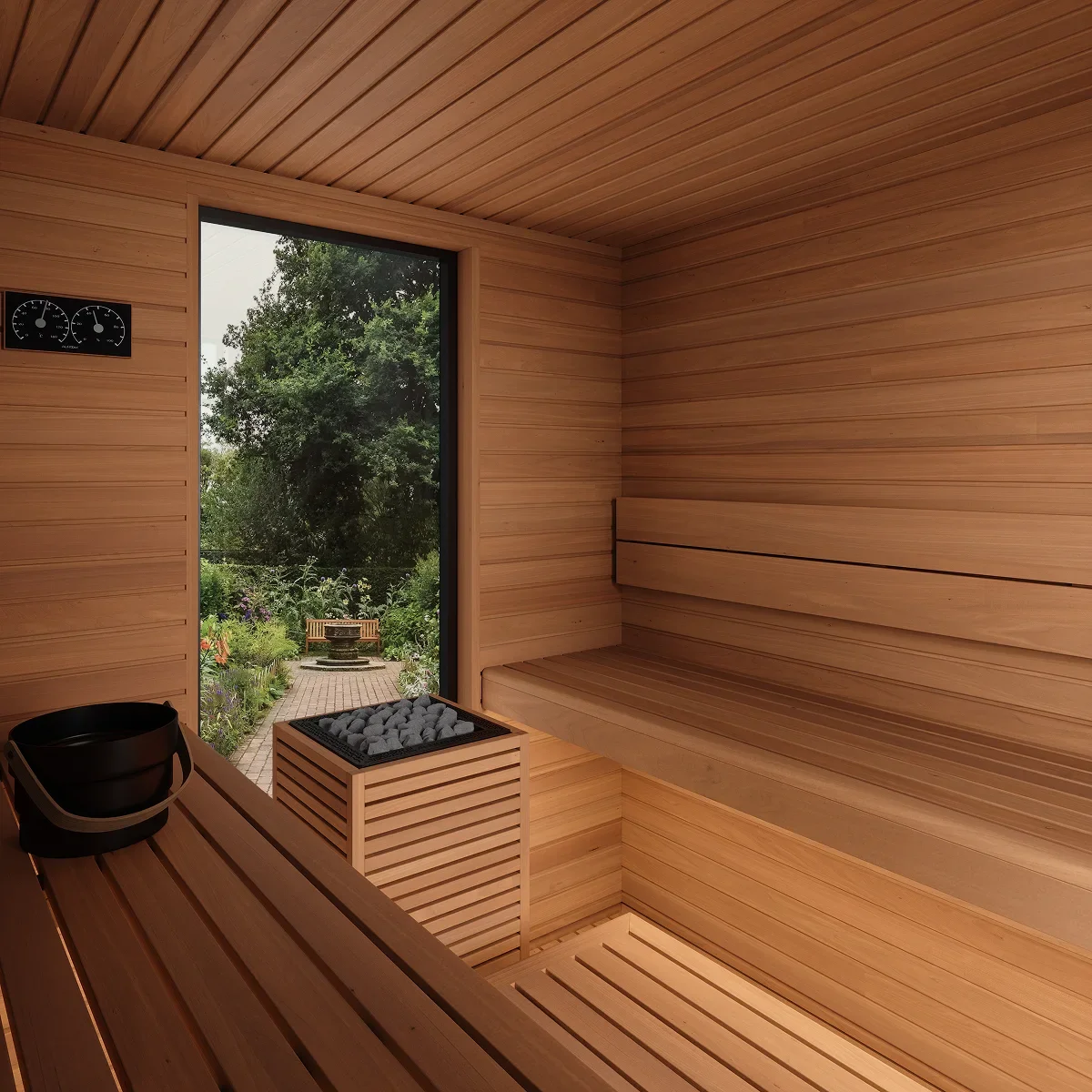 Inside a wooden sauna with a window view of a garden, a bench, and a heater with stones.