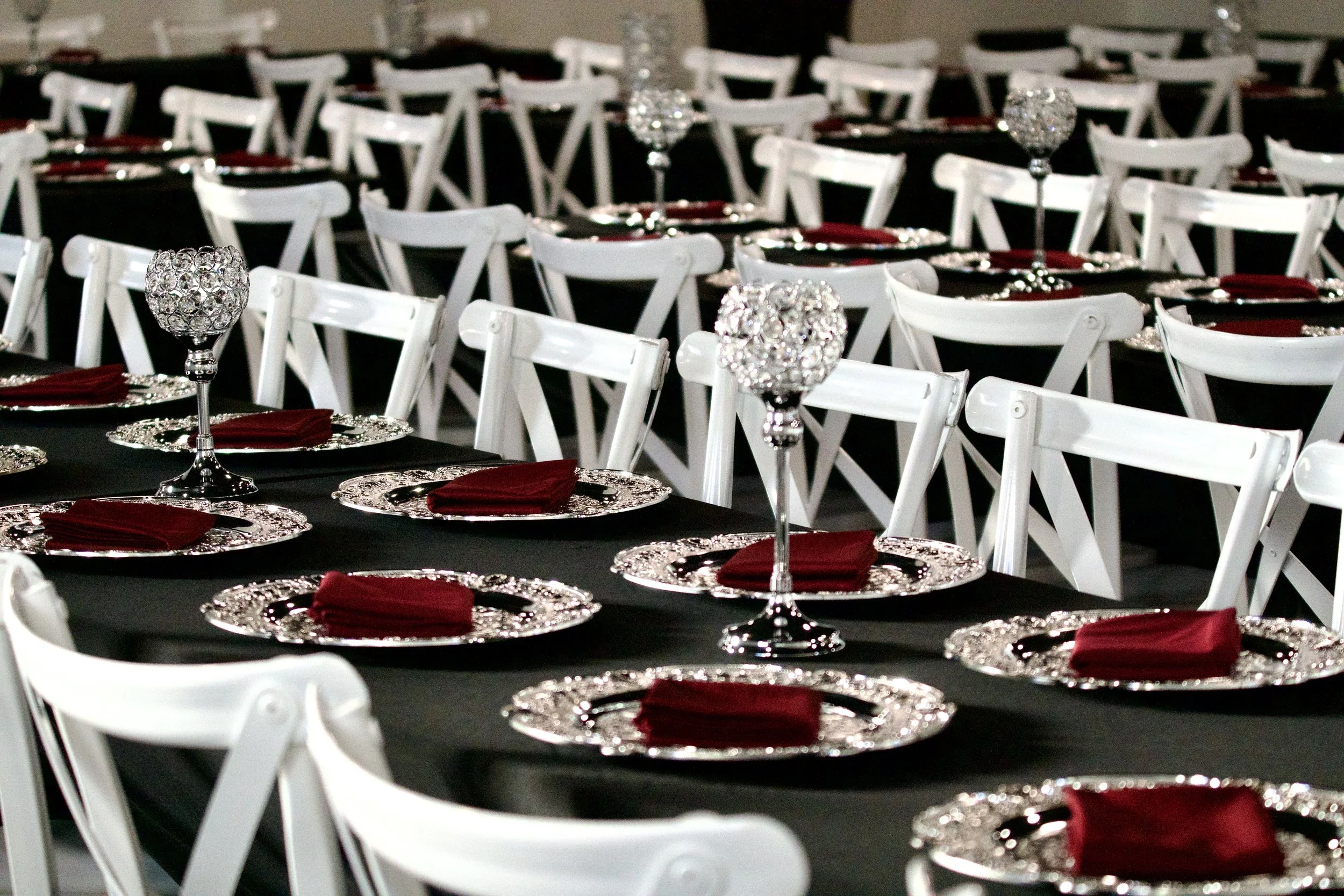 low angle view of crystal centerpieces lined down a black reception table