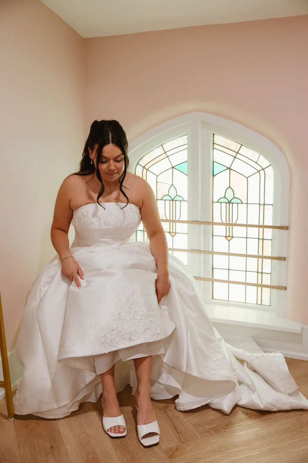 bride-putting-on-white-wedding-shoes.jpg