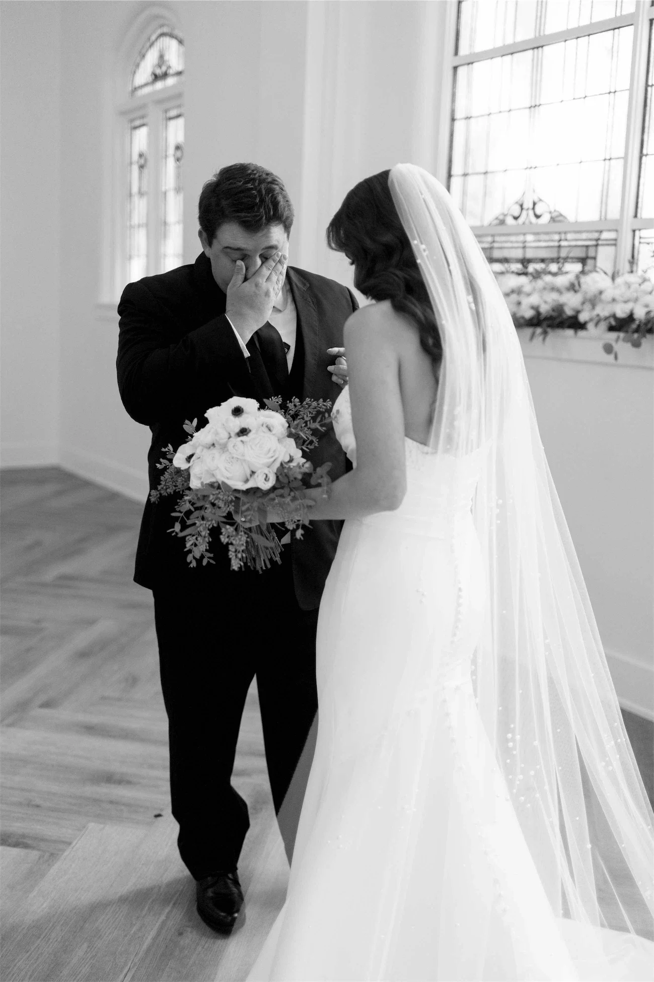 groom-tearful-first-look-black-and-white.webp