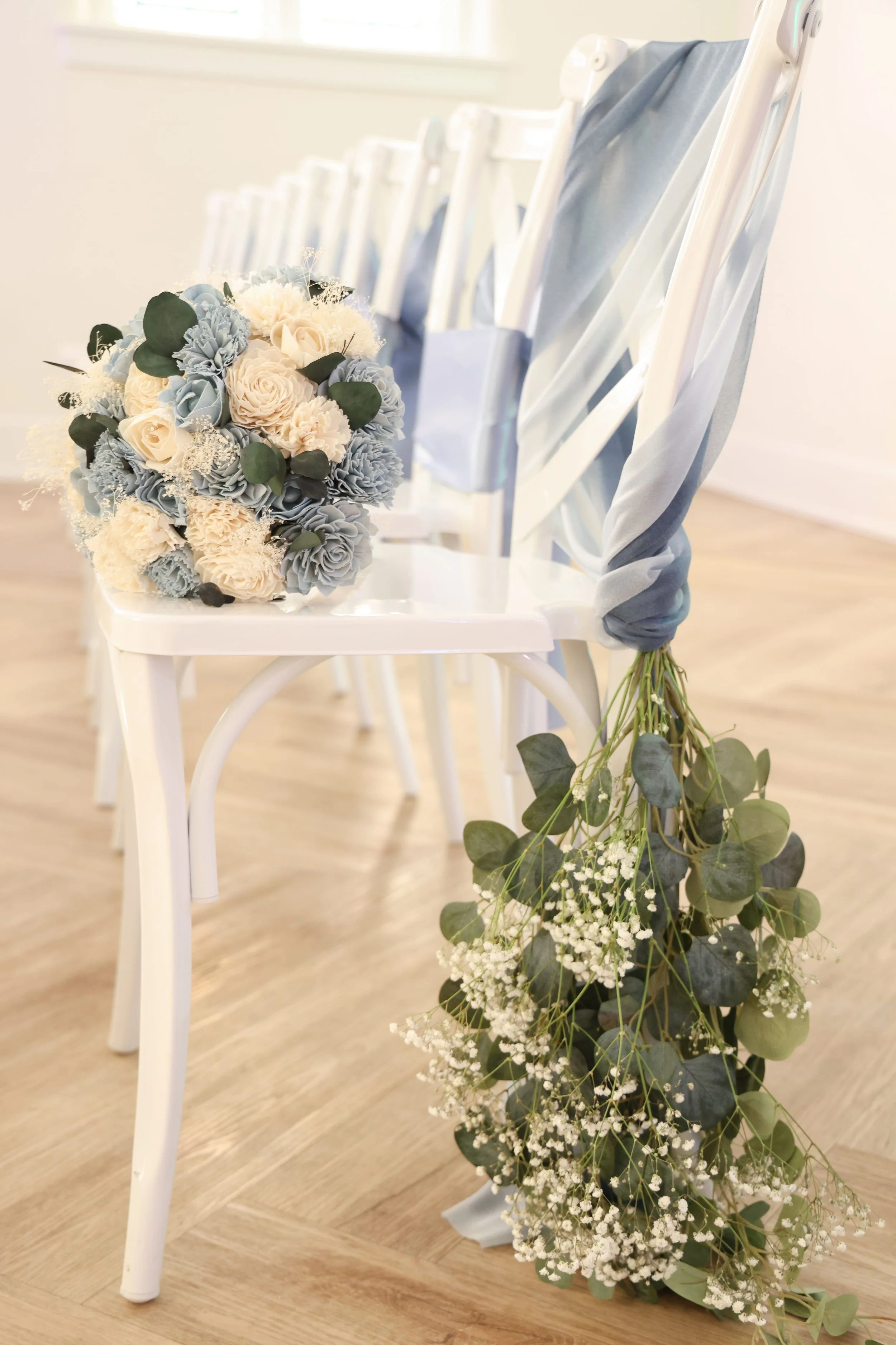 bouquet-resting-chair-eucalyptus-ceremony-aisle.jpg