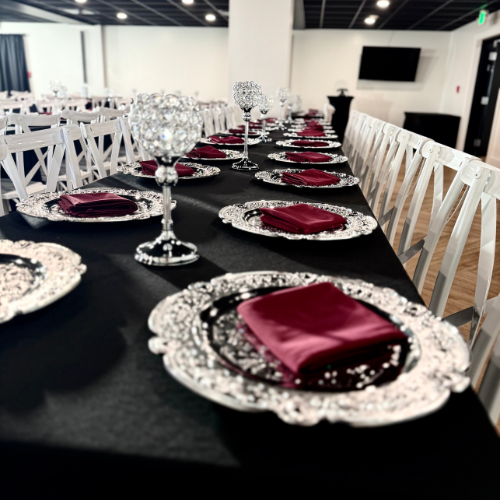 overhead angle of a Gatsby reception table with crystal centerpieces and burgundy napkins