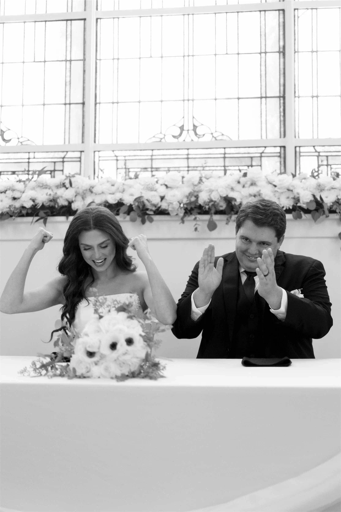 sweetheart-table-newlyweds-celebrating-black-and-white.webp