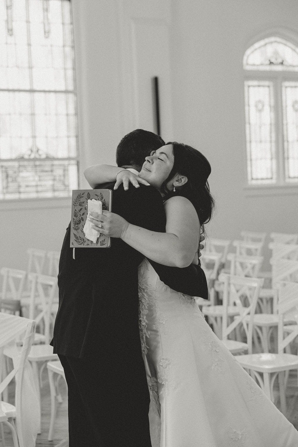 bride-and-groom-embrace-in-hug-chapel-black-and-white.jpg