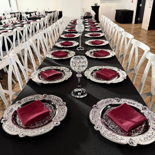 top down view of a black reception table centered on a crystal goblet candle holder