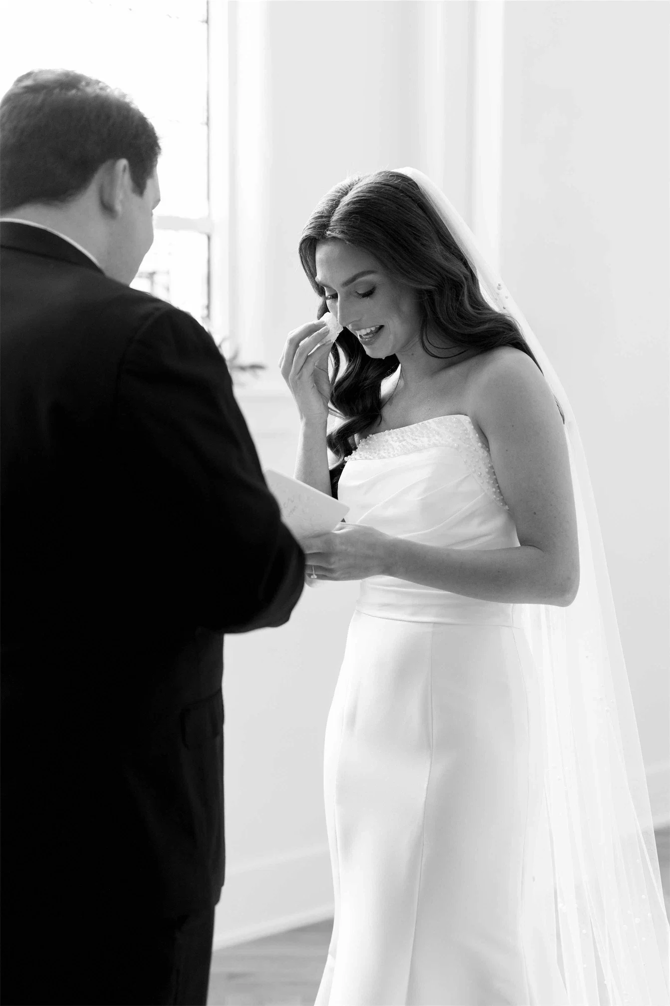 bride-reading-private-vows-tears-black-and-white.webp