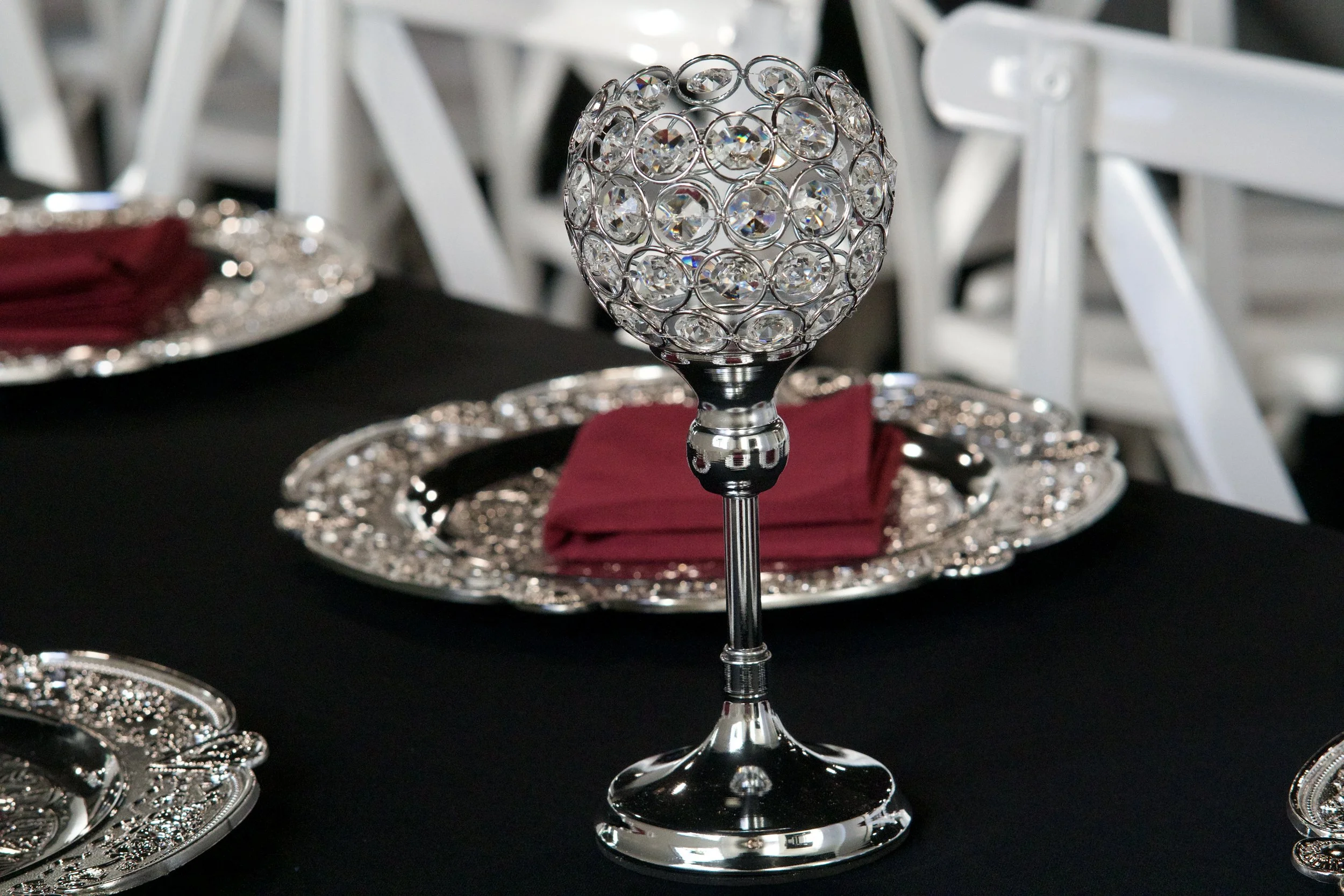 close detail of a crystal ball candle holder on a black reception tablescape