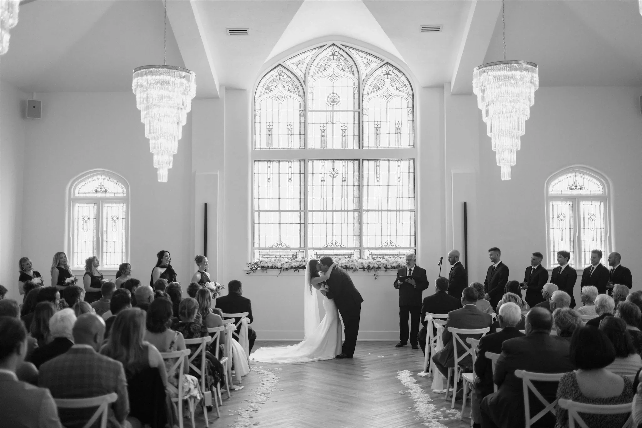 wide-ceremony-kiss-crystal-chandeliers-stained-glass.webp