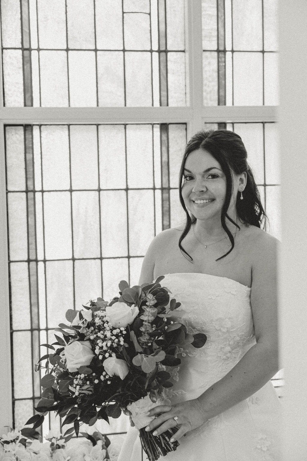 bride-sleeveless-dress-bouquet-stained-glass-window-black-and-white.jpg