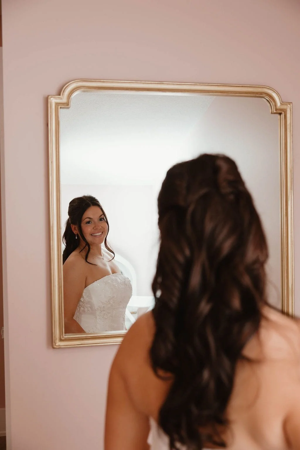 bride-in-dress-looks-in-mirror.jpg