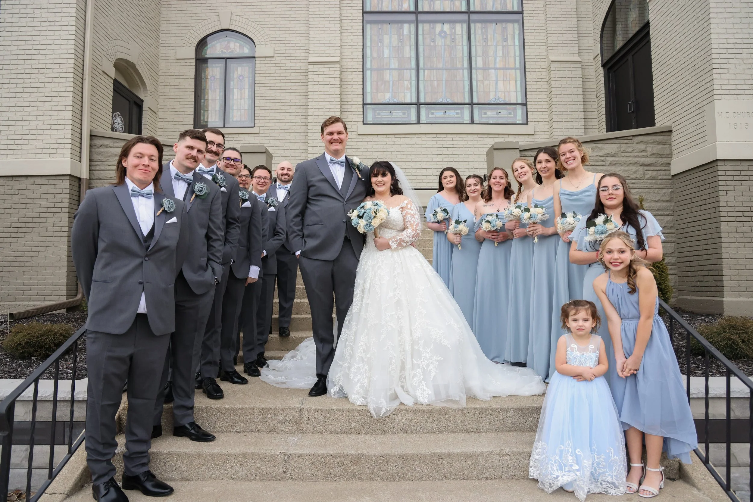 full-wedding-party-church-steps-portrait.jpg