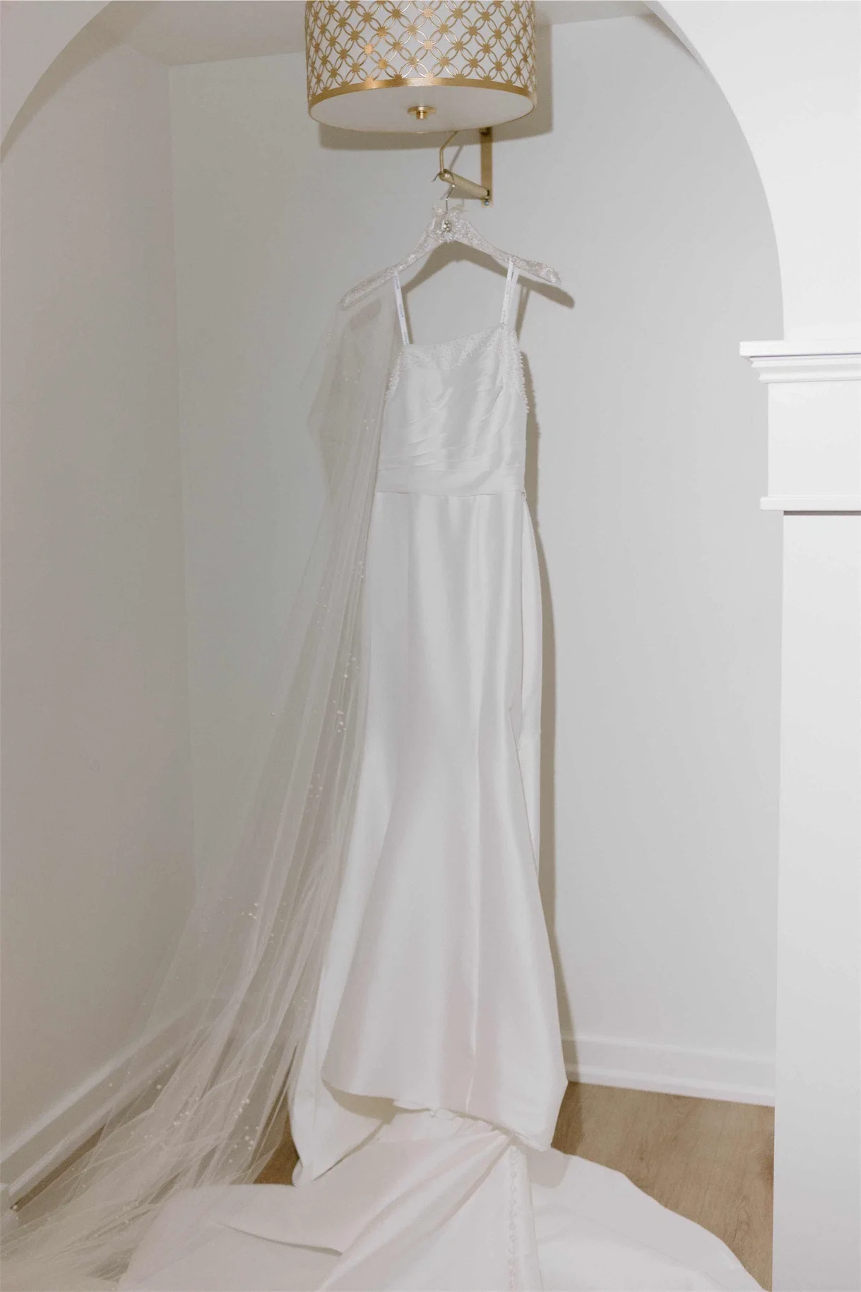 satin-wedding-dress-cathedral-veil-hanging-bridal-suite.webp