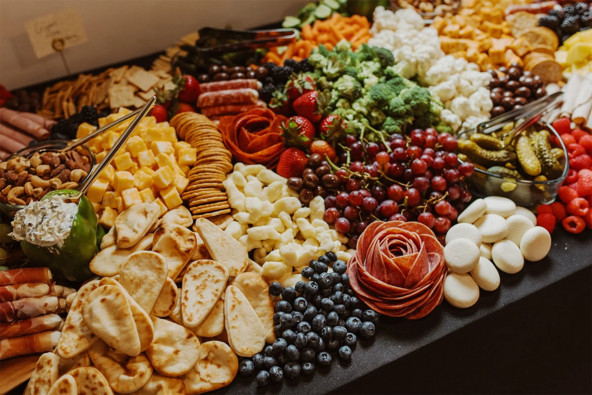 Charcuterie and grazing table spread with cheese fruit and crackers for reception